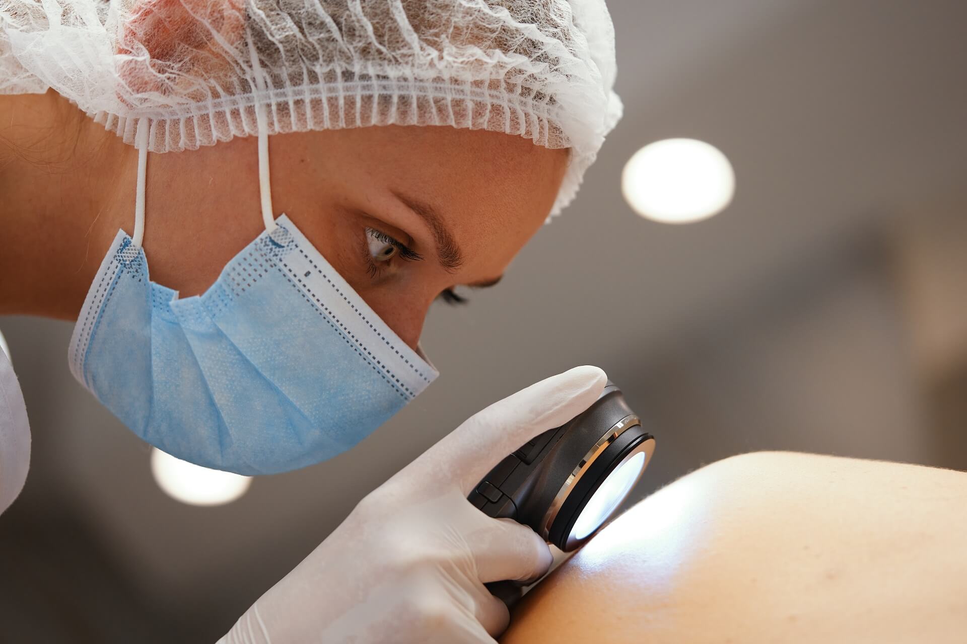 A clinician examining a skin concern before treatment